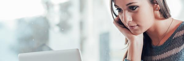 Bolsa y Mercados Particulares - Mujer de negocios joven concentrada trabajando frente a su portátil en la oficina Bolsa y Mercados Particulares - Mujer de negocios joven concentrada trabajando frente a su portátil en la oficina